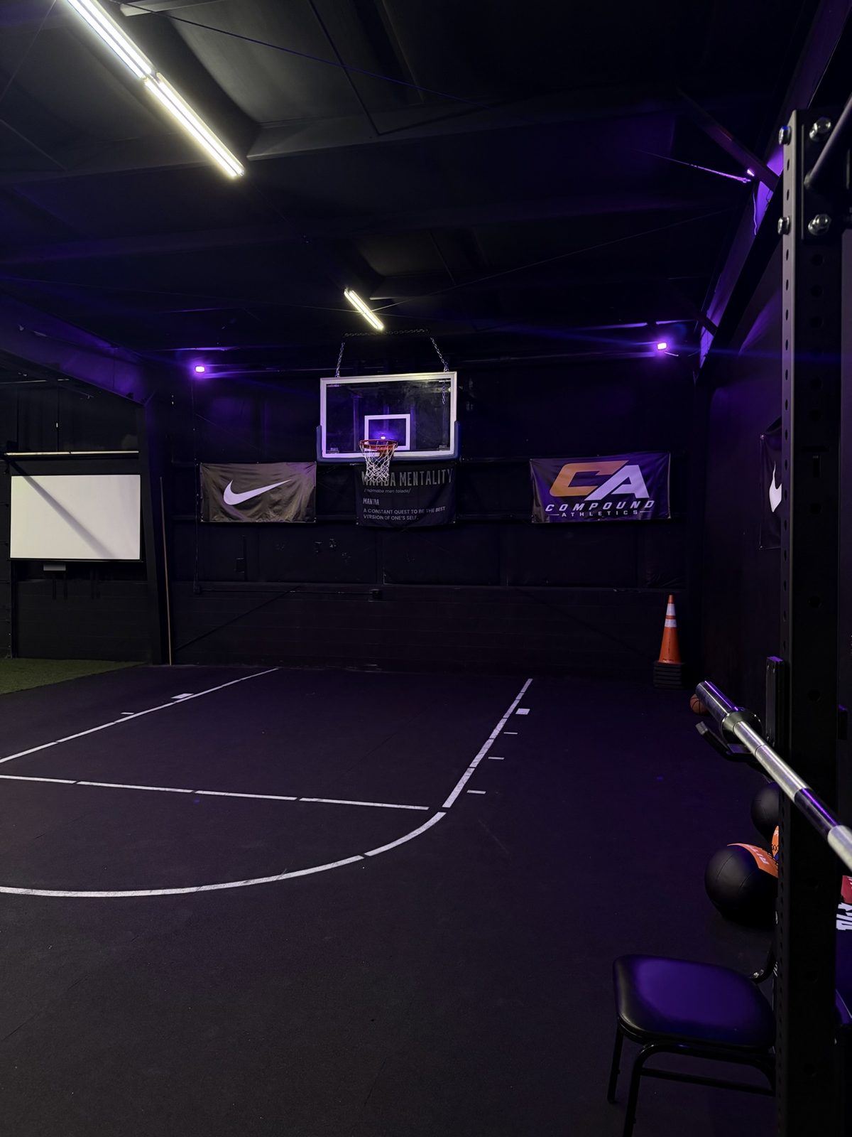 Compound Athletics training court with basketball hoop